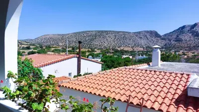 a view of a roof with mountains in the background at Sounio Poseidon Villa in Sounio