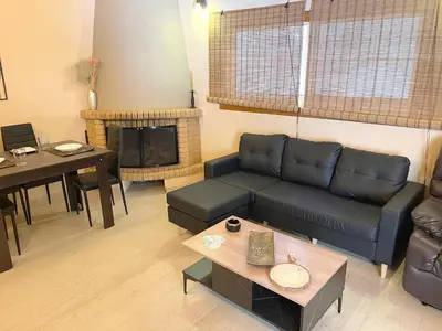 a living room with a couch and a table at Sounio Poseidon Villa in Sounio