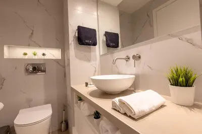 a bathroom with a bowl sink and a toilet at Acropolis Local Loft in Athens