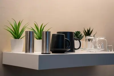 a shelf with cups and potted plants on it at Acropolis Local Loft in Athens