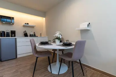 a kitchen with a table and chairs in a room at Acropolis Local Loft in Athens