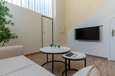 a living room with a couch and a table at Acropolis Local Loft in Athens