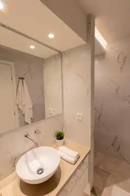 a bathroom with a sink and a mirror at Acropolis Local Loft in Athens