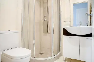 a bathroom with a shower and a toilet and a sink at Varkiza Seaside and Views Retreat with Jacuzzi in Vari