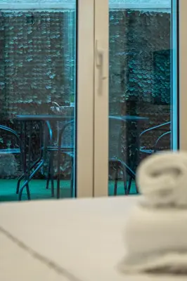 a reflection of a table and chairs in a mirror at Spacious Peaceful Family 2BD APT in Athens