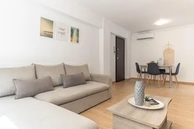 a living room with a couch and a table at Spacious Peaceful Family 2BD APT in Athens
