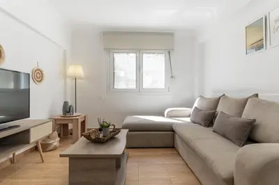 a living room with a couch and a tv at Spacious Peaceful Family 2BD APT in Athens