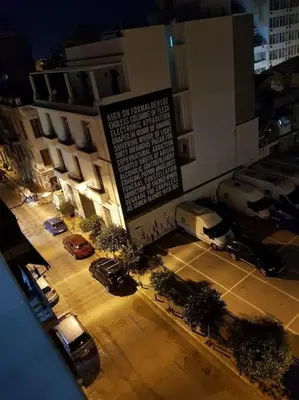 an overhead view of a parking lot with parked cars at Unforgettable holidays two steps from Acropolis 3 in Athens