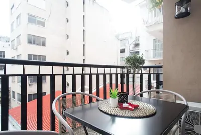 a black table and chairs on a balcony at Unforgettable holidays two steps from Acropolis 3 in Athens