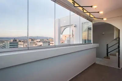 a room with large windows with a view of a city at Unforgettable holidays two steps from Acropolis 3 in Athens