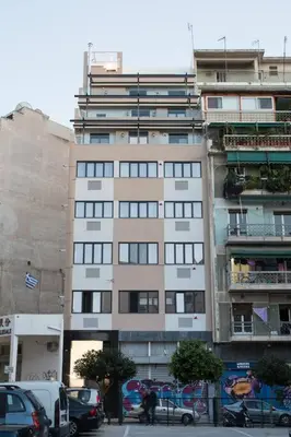 a tall building with cars parked in front of it at Unforgettable holidays two steps from Acropolis 3 in Athens