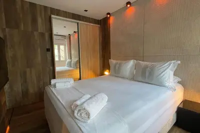 a bedroom with a large white bed with towels on it at Alfa Luxury Home 3 in Athens