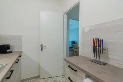 a kitchen with white walls and a counter with a sink at Coloneum 1BD Cozy Apartment in Athens Kolonos in Athens