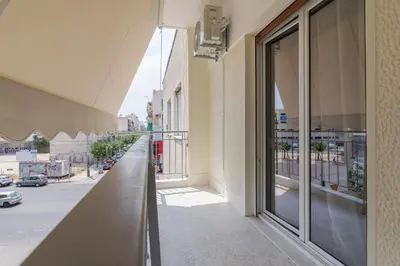 an empty balcony of a building with a view of a street at Coloneum 1BD Cozy Apartment in Athens Kolonos in Athens