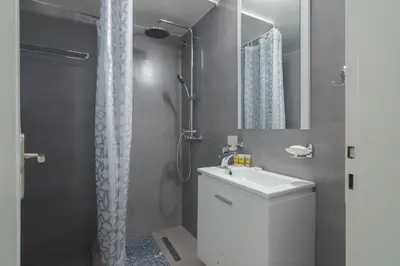 a bathroom with a white sink and a shower at Coloneum 1BD Cozy Apartment in Athens Kolonos in Athens