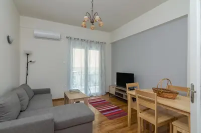 a living room with a couch and a dining room table at Coloneum 1BD Cozy Apartment in Athens Kolonos in Athens