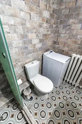 a bathroom with a toilet in a brick wall at Flower in Athens