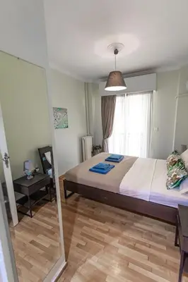 a bedroom with a large bed and a window at Flower in Athens