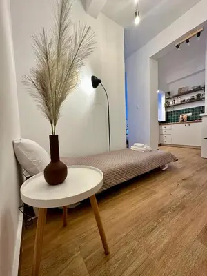 a room with a bed and a table with a vase on it at Urban Retreat , Psirri Athens City Center in Athens