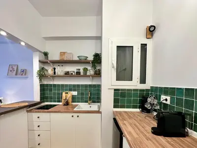 a kitchen with a sink and green tiles at Urban Retreat , Psirri Athens City Center in Athens