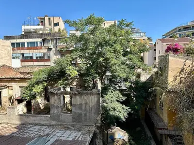 an old building with a tree in a city at Urban Retreat , Psirri Athens City Center in Athens