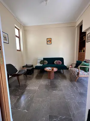 a living room with a couch and a table at Midcentury Modern Apartment in Piraeus