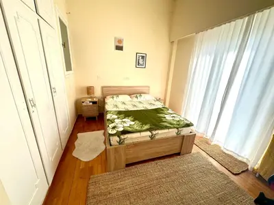 a small bedroom with a bed and a window at Midcentury Modern Apartment in Piraeus