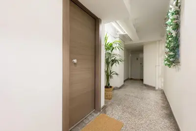 a corridor of an office with a door and plants at Elegant Athens Downtown Studio in Athens