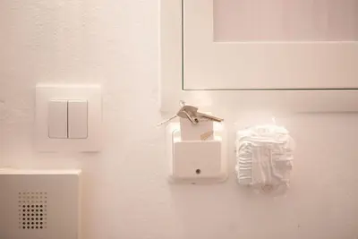 a white wall with a lightswitch and a box at Elegant Athens Downtown Studio in Athens