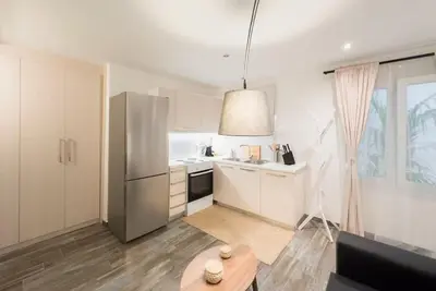 a kitchen with a stainless steel refrigerator and a table at Elegant Athens Downtown Studio in Athens