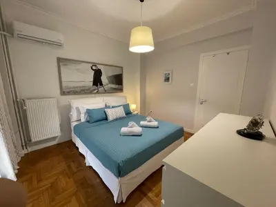 a bedroom with a bed with towels on it at Kate's Nest Athens in Athens