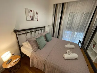 a bedroom with a bed with towels on it at Kate's Nest Athens in Athens