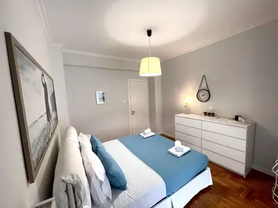 a small bedroom with a bed and a dresser at Kate's Nest Athens in Athens