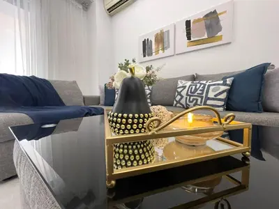 a living room with a couch and a glass table at Kate's Nest Athens in Athens