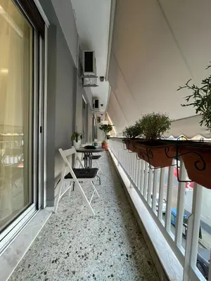 a balcony with a table and chairs on it at Kate's Nest Athens in Athens