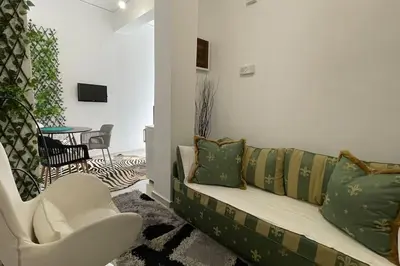 a living room with a couch and a chair at Alfa house in the center! in Athens