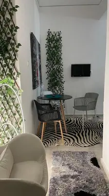 a living room with a table and chairs at Alfa house in the center! in Athens