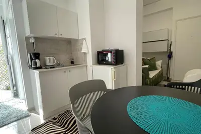 a kitchen with a table and chairs in a room at Alfa house in the center! in Athens