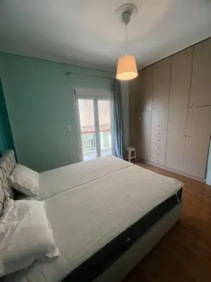 a large bed in a bedroom with a window at Sunny Escape in Alimos, close to the beach in Athens