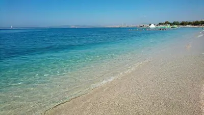 a beach with clear blue water and a rocky shore at Sunny Escape in Alimos, close to the beach in Athens