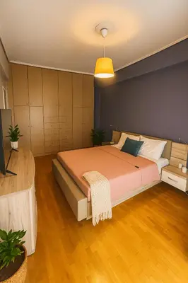 a bedroom with a large bed in a room at Sunny Escape in Alimos, close to the beach in Athens