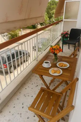 a balcony with a table with food on it at Sunny Escape in Alimos, close to the beach in Athens