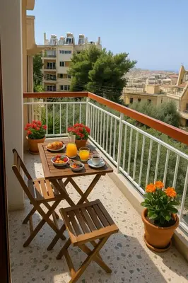 a table and chairs on a balcony with food on it at Sunny Escape in Alimos, close to the beach in Athens