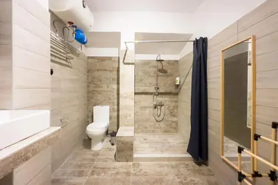 a bathroom with a shower and a toilet and a sink at Modern Comfort Apt near centre in Athens