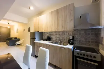 a kitchen with a sink and a stove top oven at Modern Comfort Apt near centre in Athens