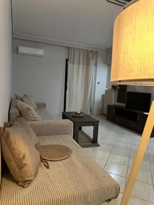 a living room with a couch and a table at Piraeus Seaside Apartment Escape in Piraeus
