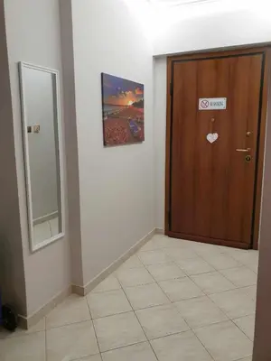 a room with a wooden door and a mirror at Piraeus Seaside Apartment Escape in Piraeus