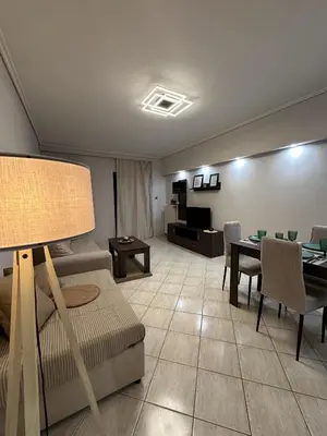 a living room with a couch and a table at Piraeus Seaside Apartment Escape in Piraeus
