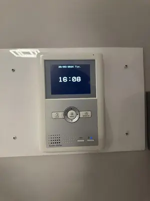a tv on a wall with a clock on it at Piraeus Seaside Apartment Escape in Piraeus