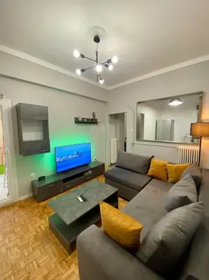 a living room with a couch and a flat screen tv at Sweety Flat Marina Zeas Piraeus in Piraeus